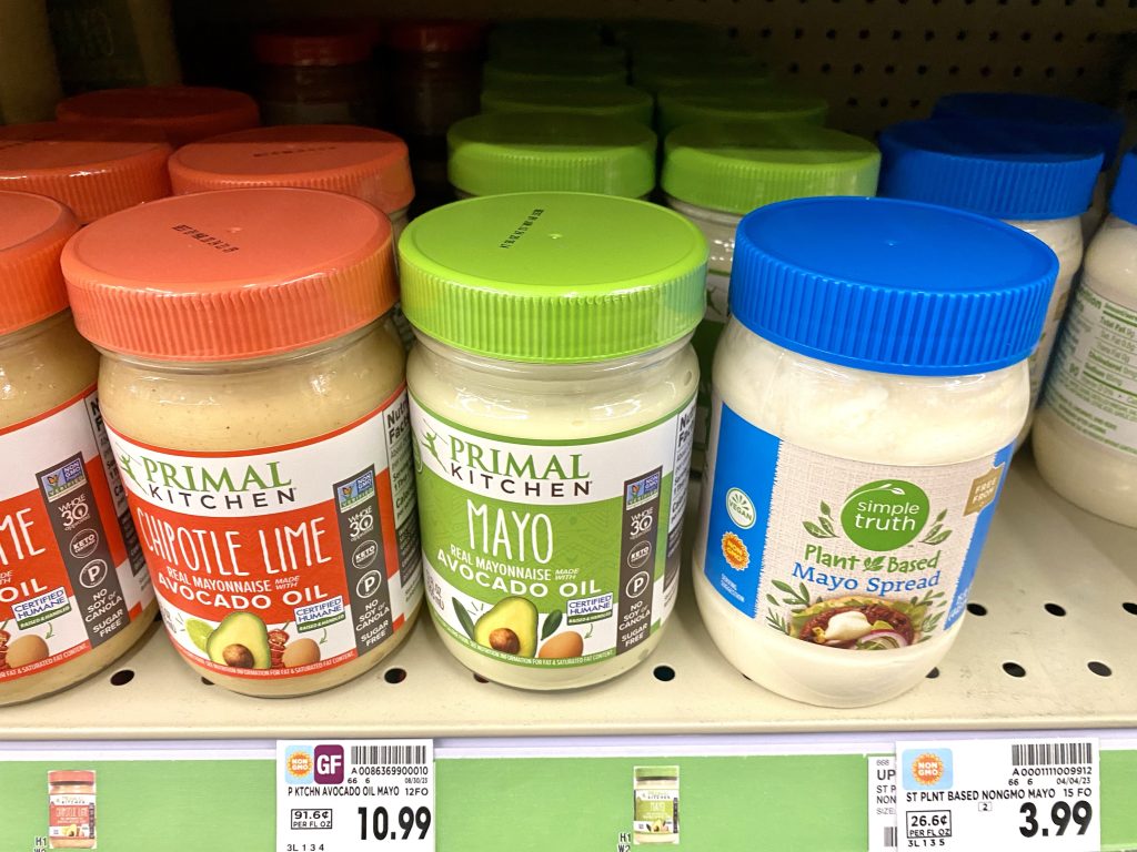 Containers of avocado mayo on store shelf.