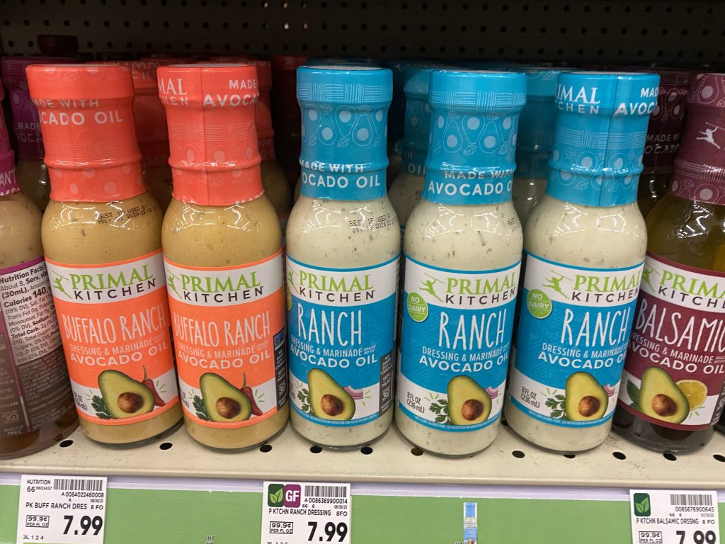 Several flavors Primal kitchen dressings on the grocery shelf.  