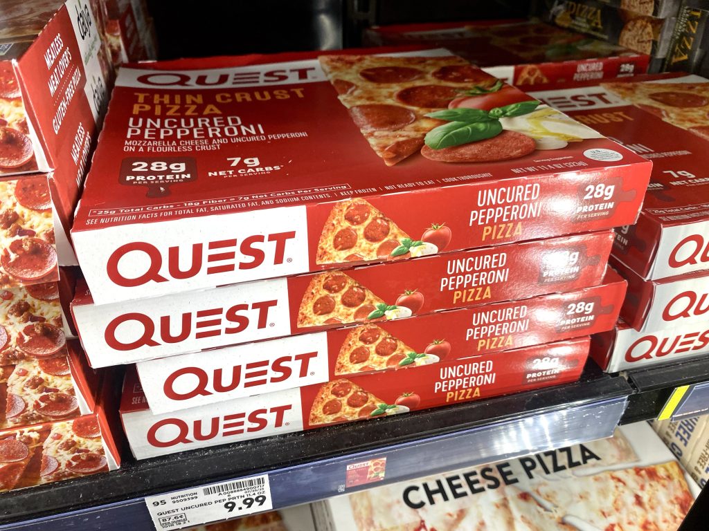 Boxes of low carb pizza in freezer at store.