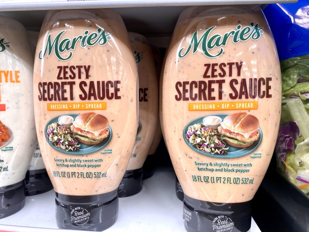 Secret sauce, burger sauce bottles on a grocery shelf.