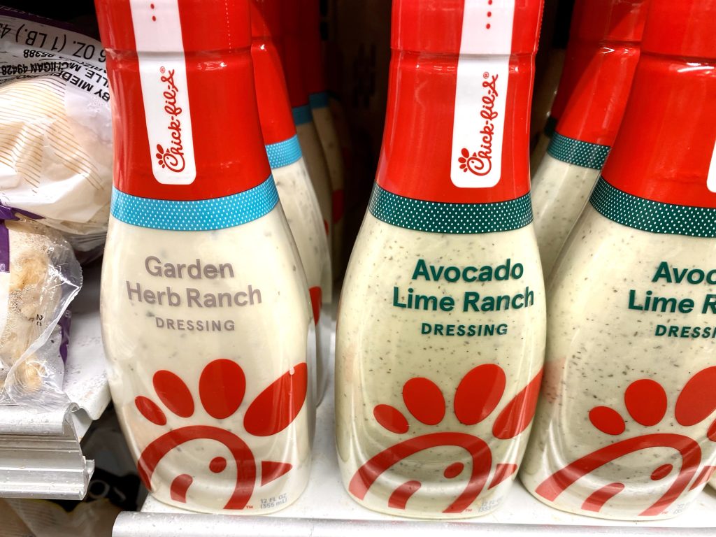 three flavors of chickfila sauce on grocery shelf.