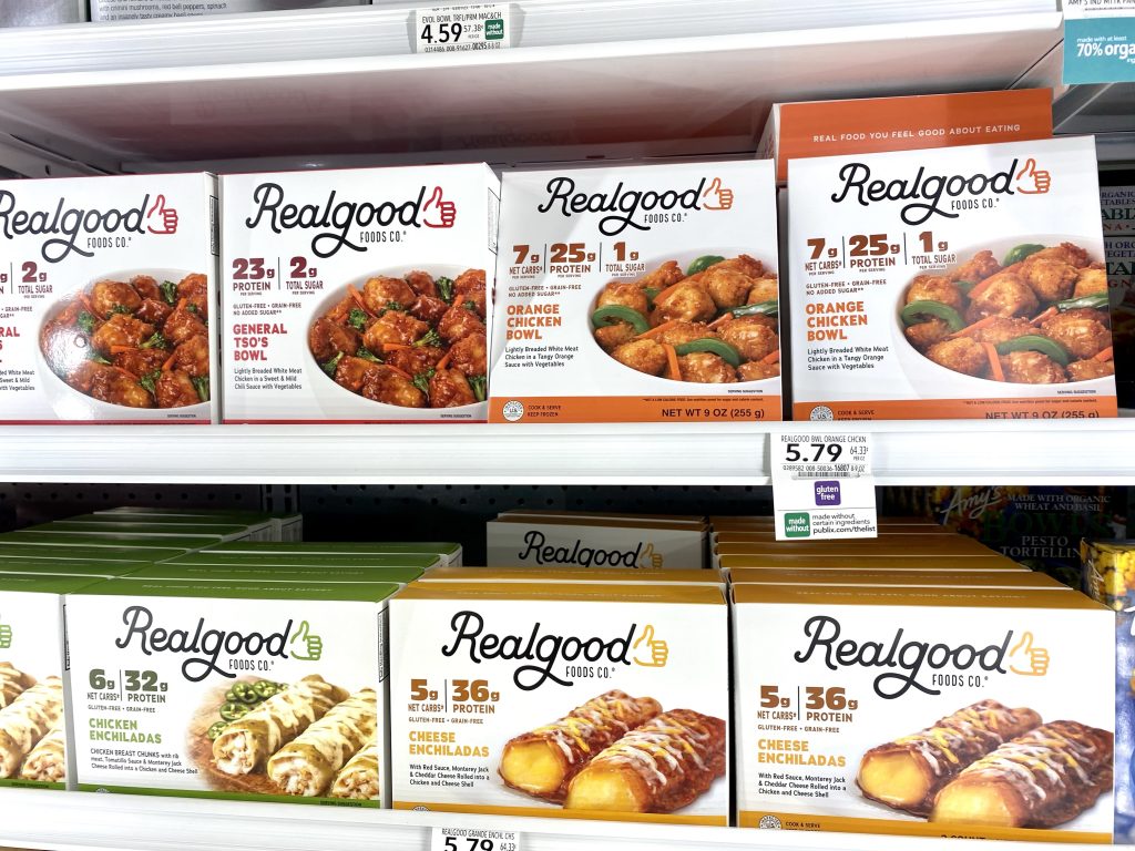 a variety of real good foods meals in the freezer section of grocery store.