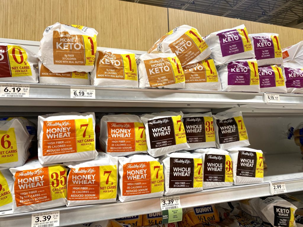 A variety of keto breads on a grocery store shelf.