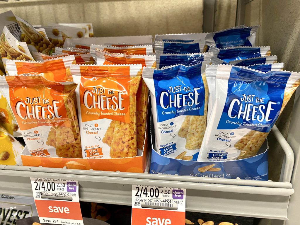 Packages of Crispy low carb cheese crackers on store shelf.
