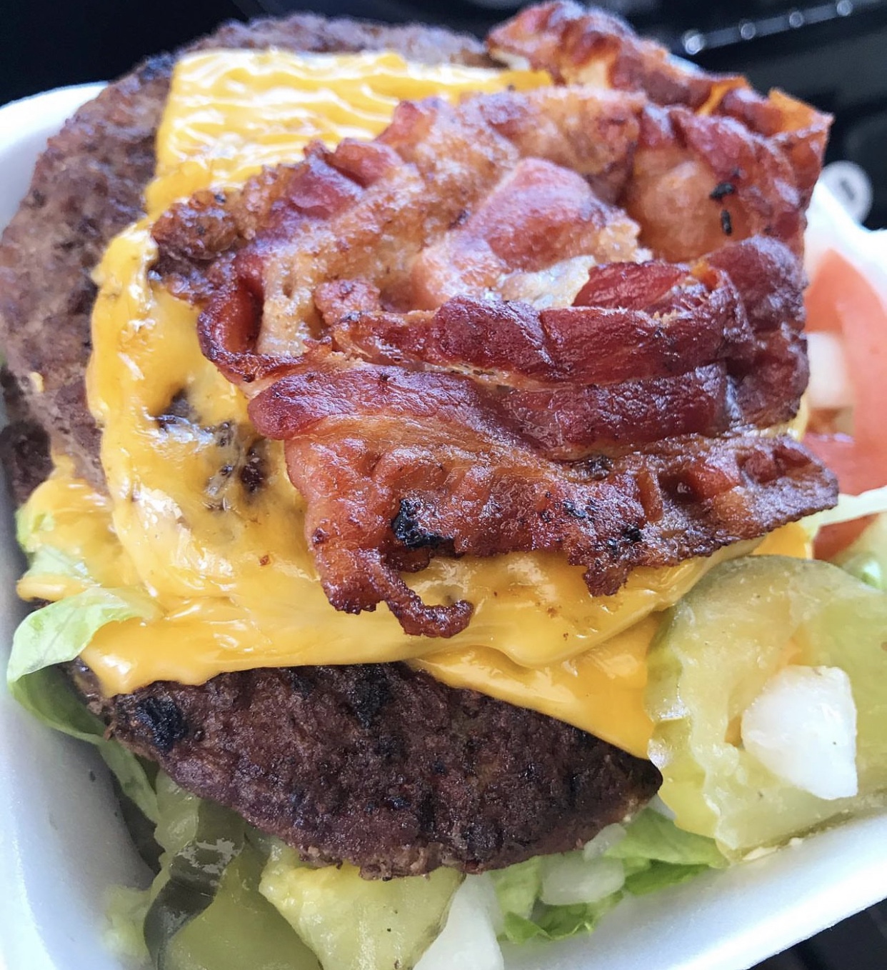 Sonic bunless bacon cheeseburger in a styrofoam container.