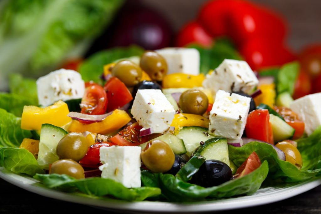 Greek salad on a white plate.