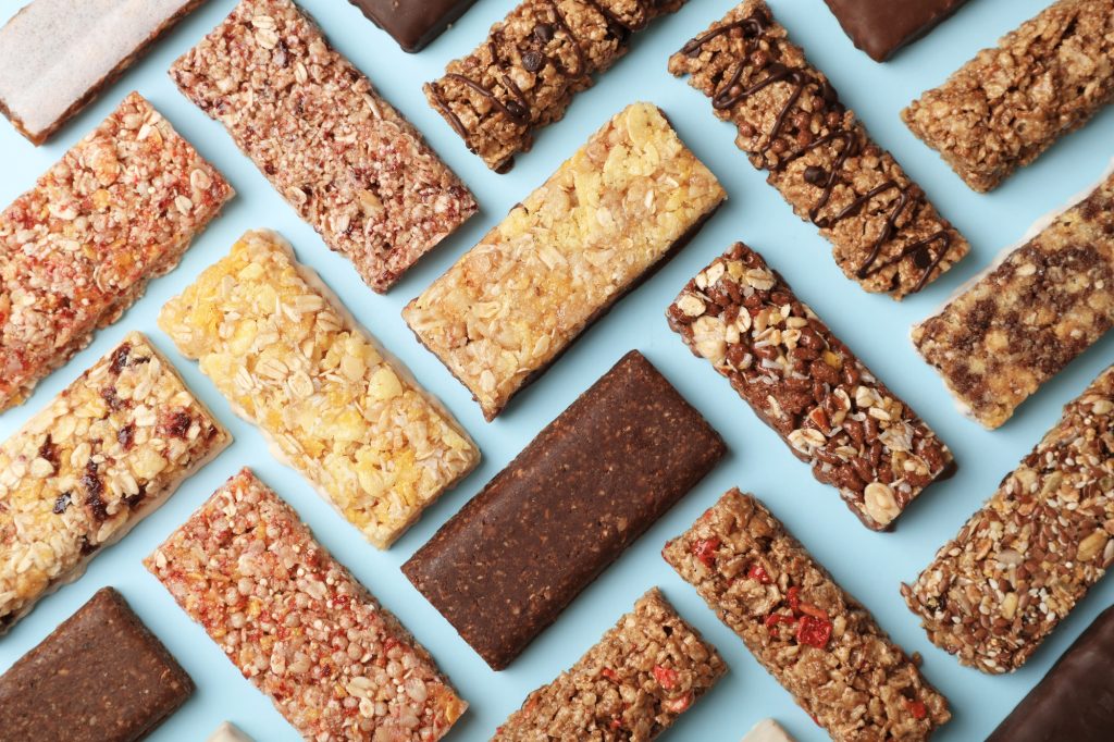 A variety of protein bars laying in a chevron pattern.