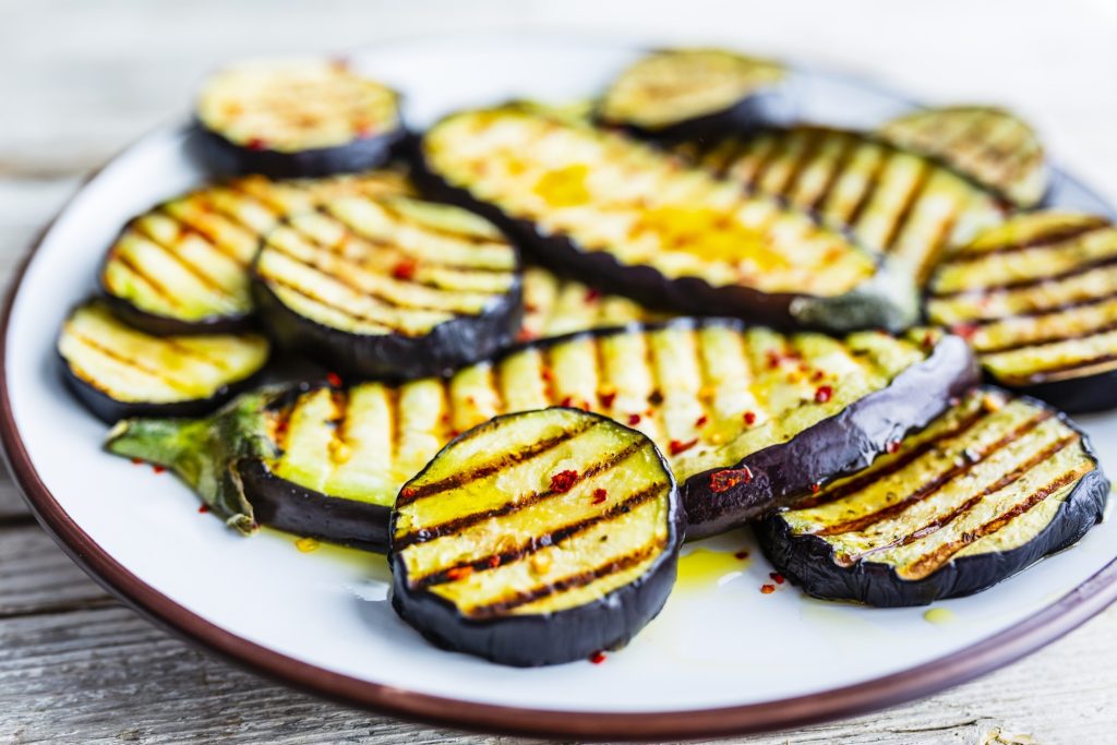 Slices of grilled Eggplant on a white plate