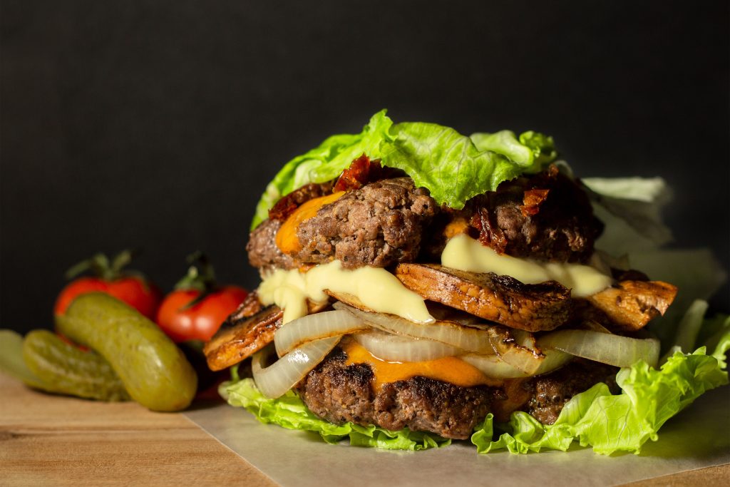 Lettuce wrapped double hamburger with veggies.