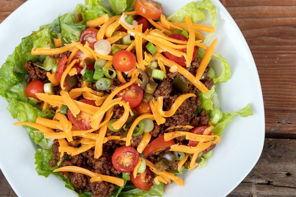 Taco salad in a white bowl.