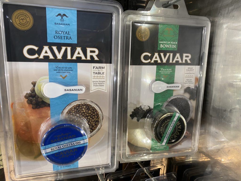 Packages of Caviar hanging in the refrigerator section of the grocery.