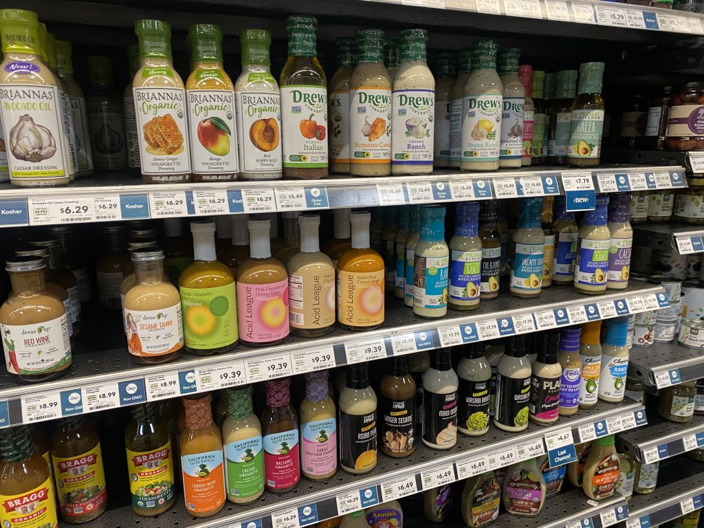 Bottles of salad dressings on the grocery shelf.