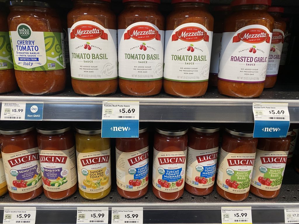 Jars of marinara sauce on shelf at the grocery.