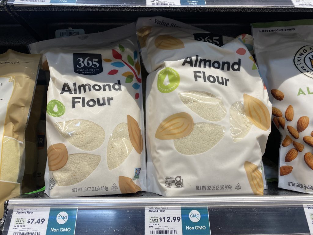 Bags of almond flour on the grocery shelf.