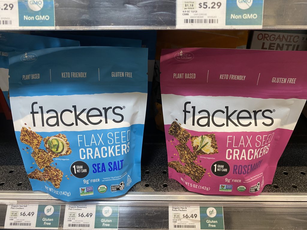 Packages of flaxseed crackers on shelf at the grocery.