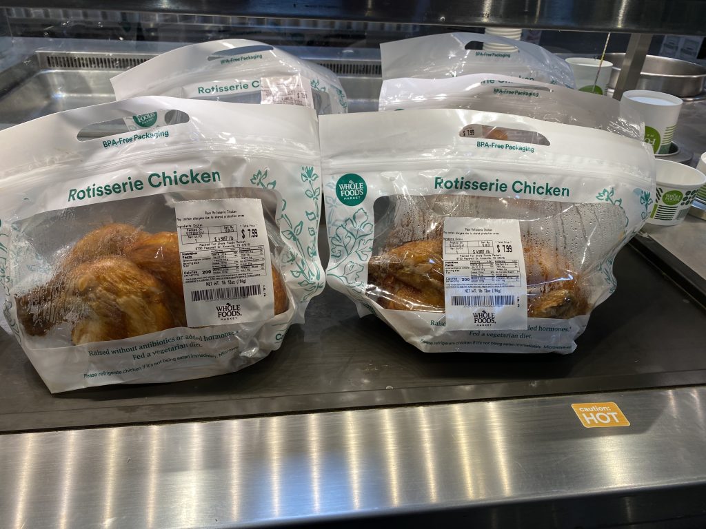 Fresh cooked rotisserie chicken in a hot box at Whole Foods Market