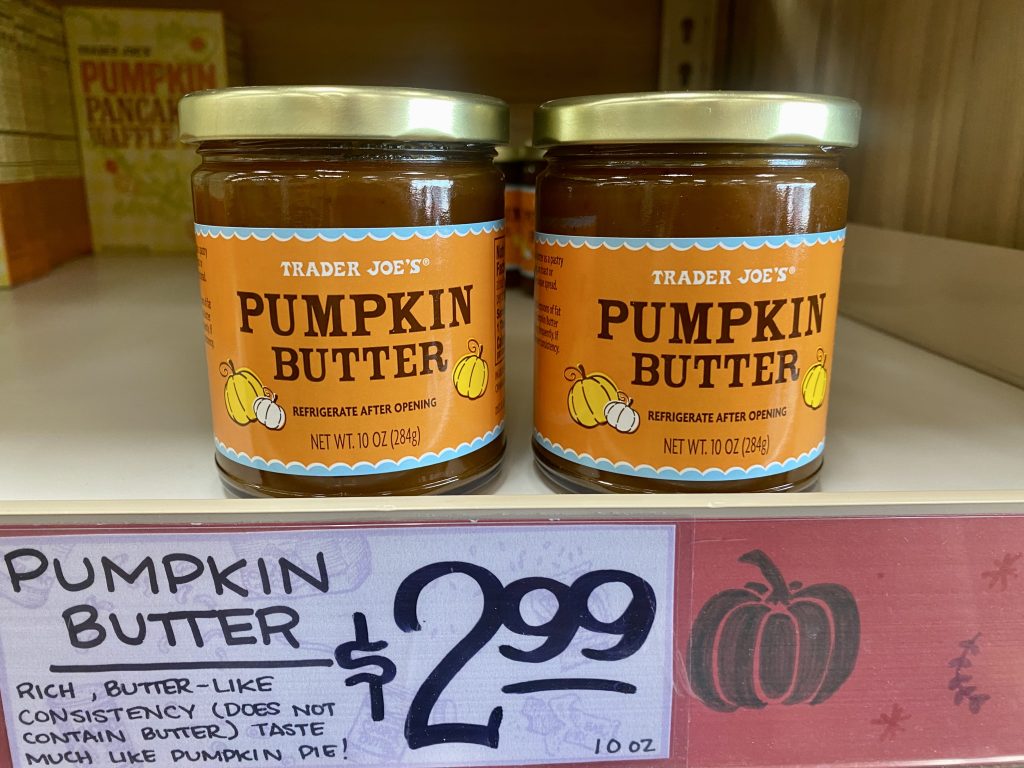 Jars of pumpkin butter on shelf at grocery.