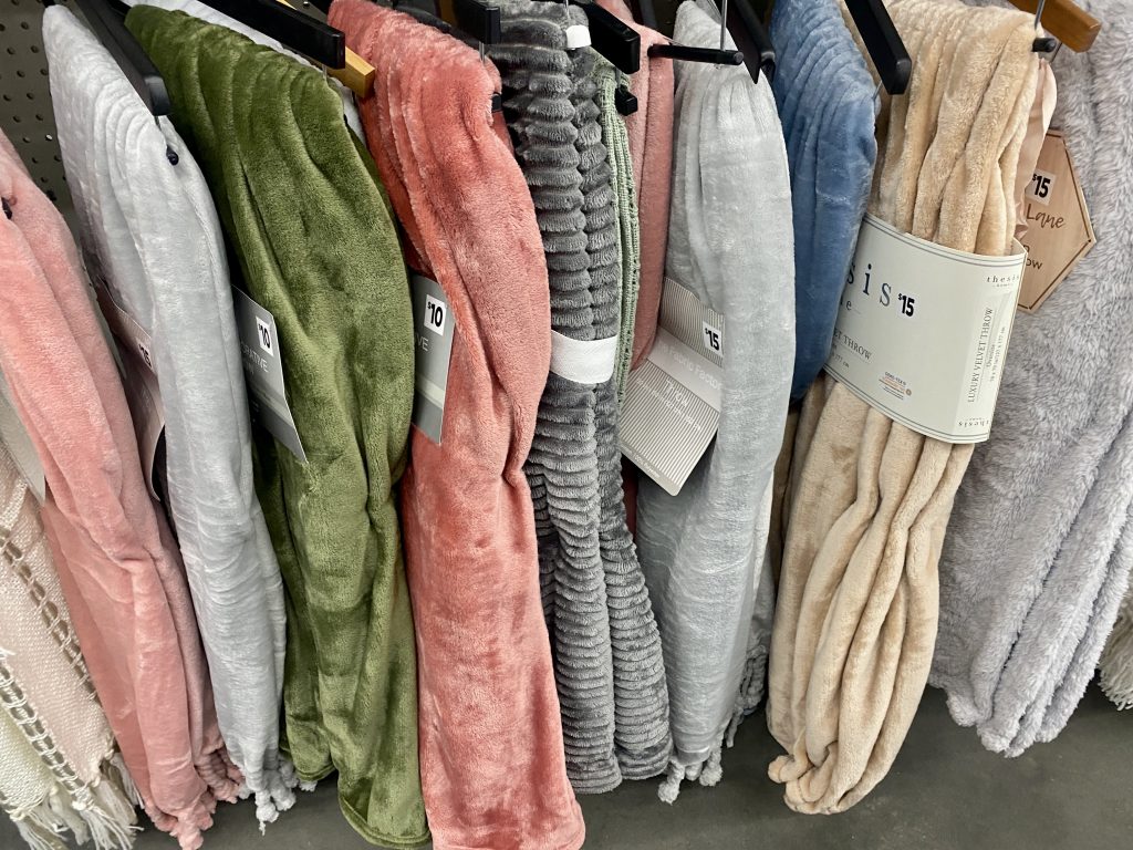 Blankets on hangers in store.