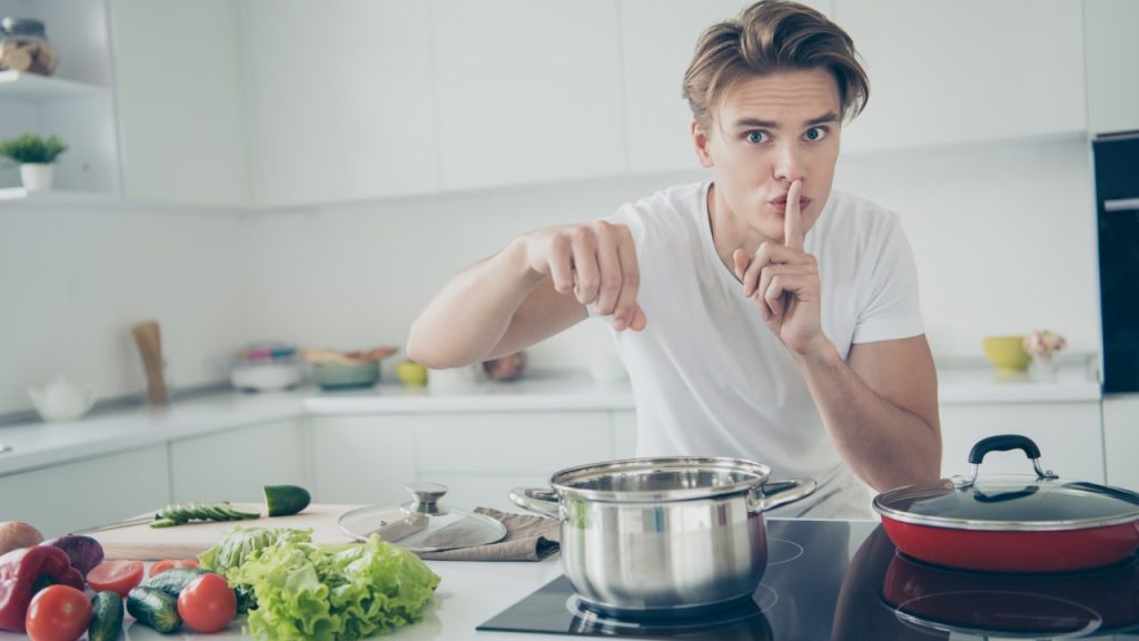 man in kitchen cooking.