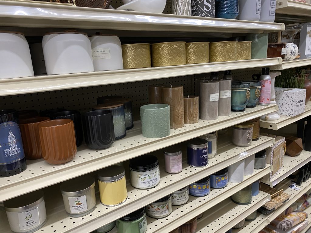 Scented candles for sale on store shelf.