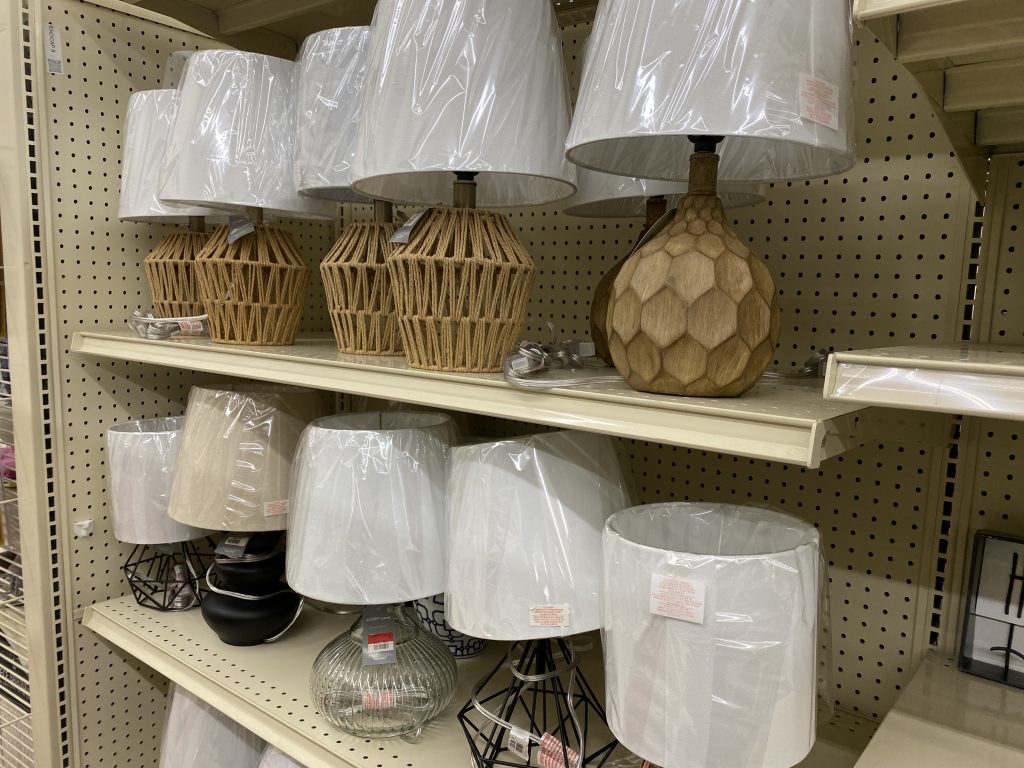 table lamps on a shelf at a store.