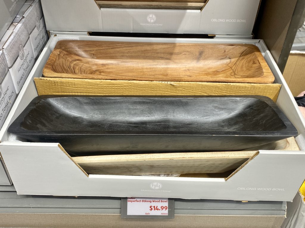 Decorative wood bowls for sale on store shelf.