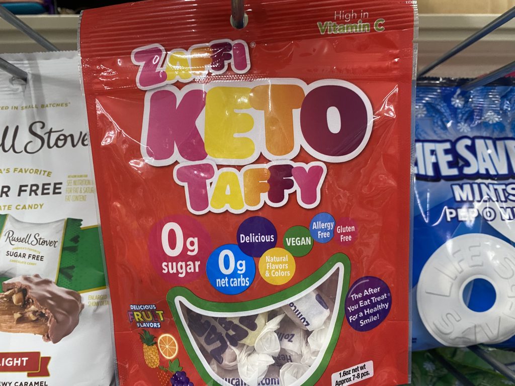 Bags of keto taffy on a store shelf.