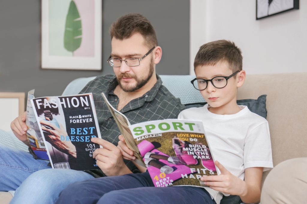 man and son reading magazines.