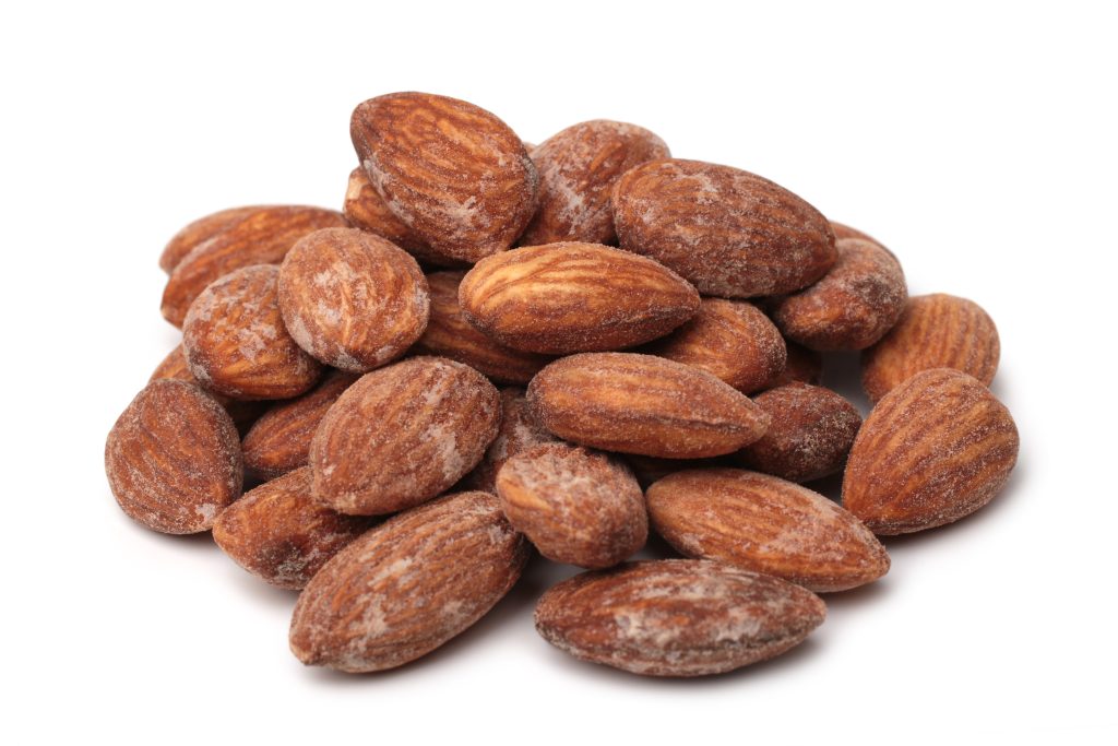 A pile of almonds on a white background.