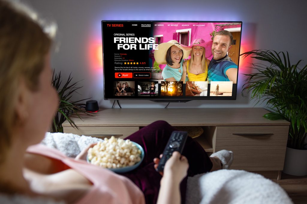 A woman watching a streaming service on tv.