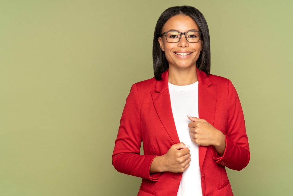 a woman wearing a red blazer and white shirt