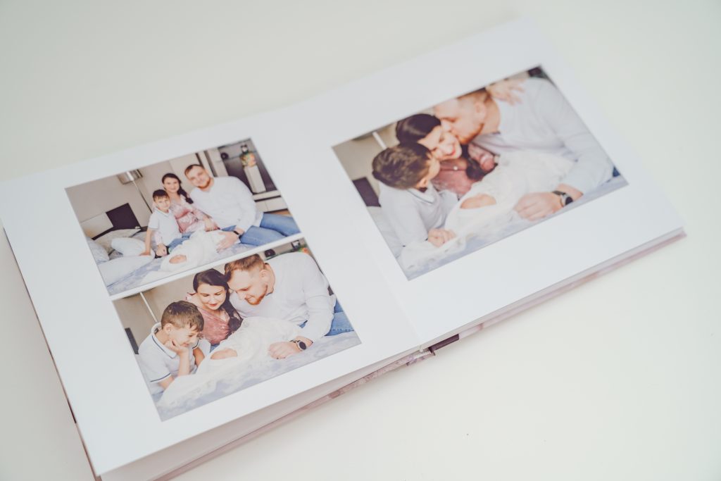 A photo book with photos of a family and newborn baby.