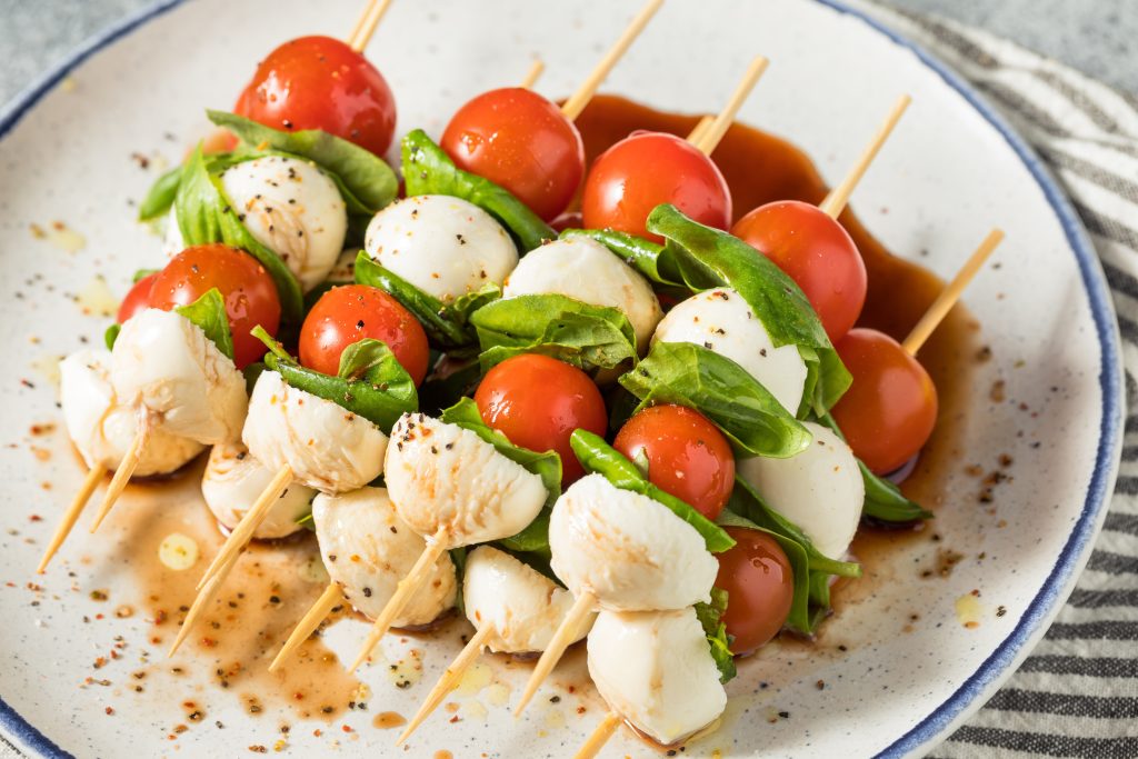 Caprese Skewers. tomato, mozzarella and basil on a wooden stick.