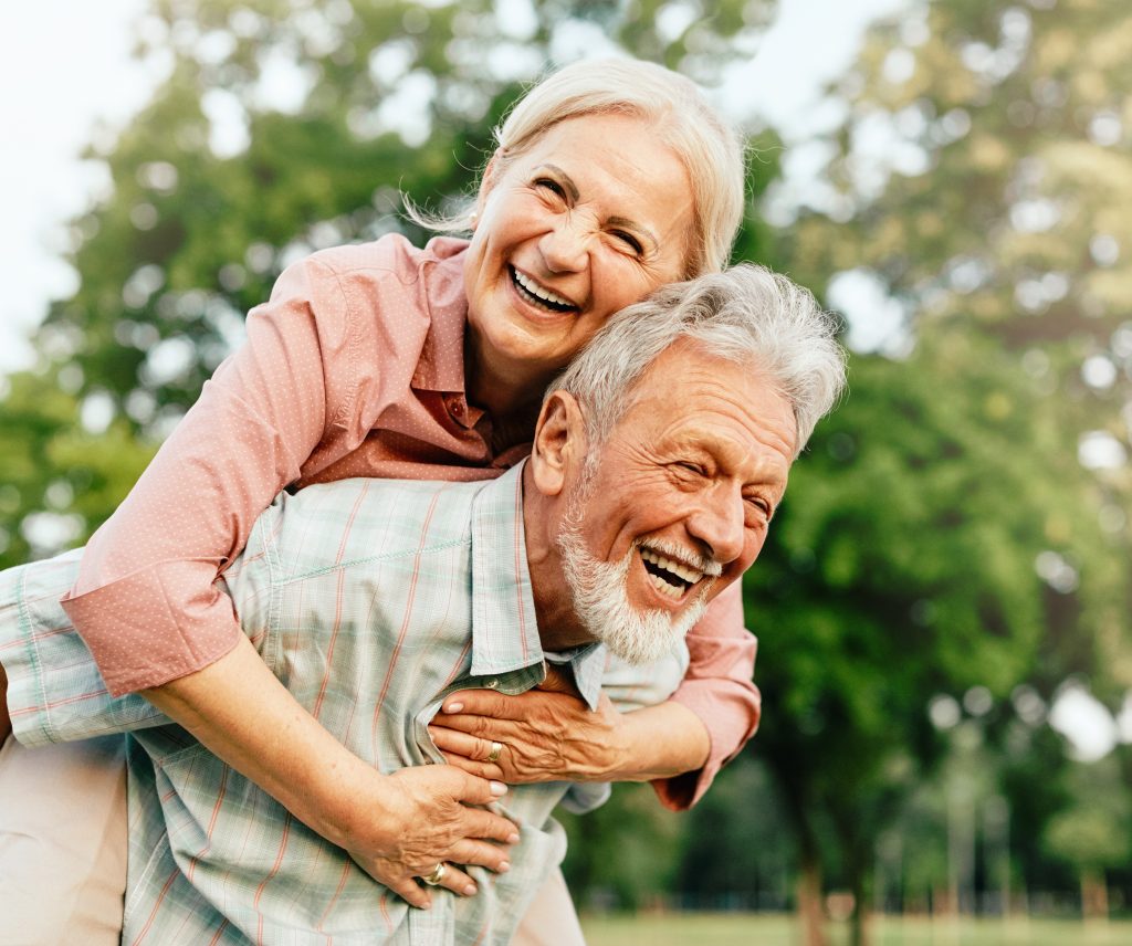 Happy older man and woman, smiling and laughing.