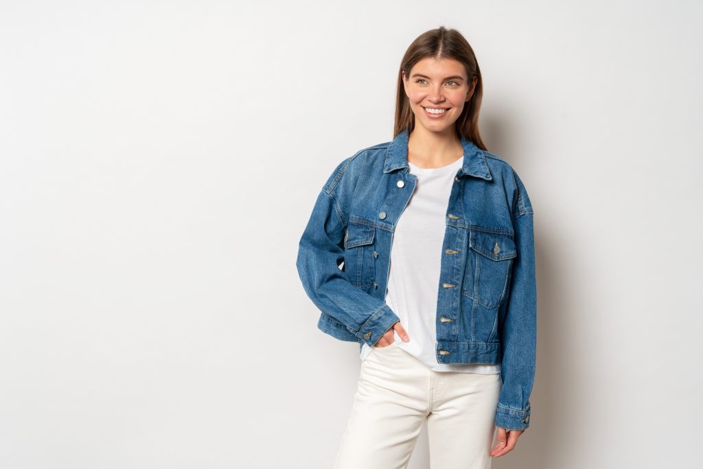 a woman wearing a classic jean jacket, white shirt and pants.