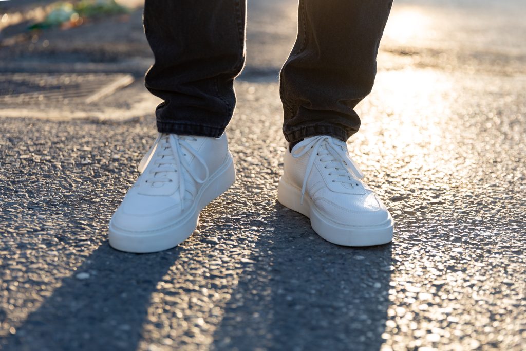 white sneakers on feet.