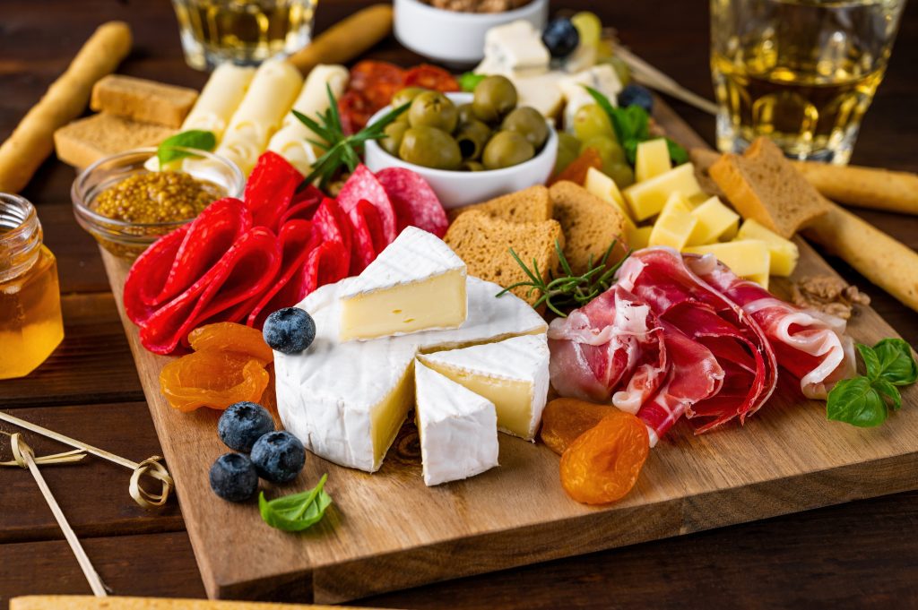 A charcuterie board filled with meats and cheeses.