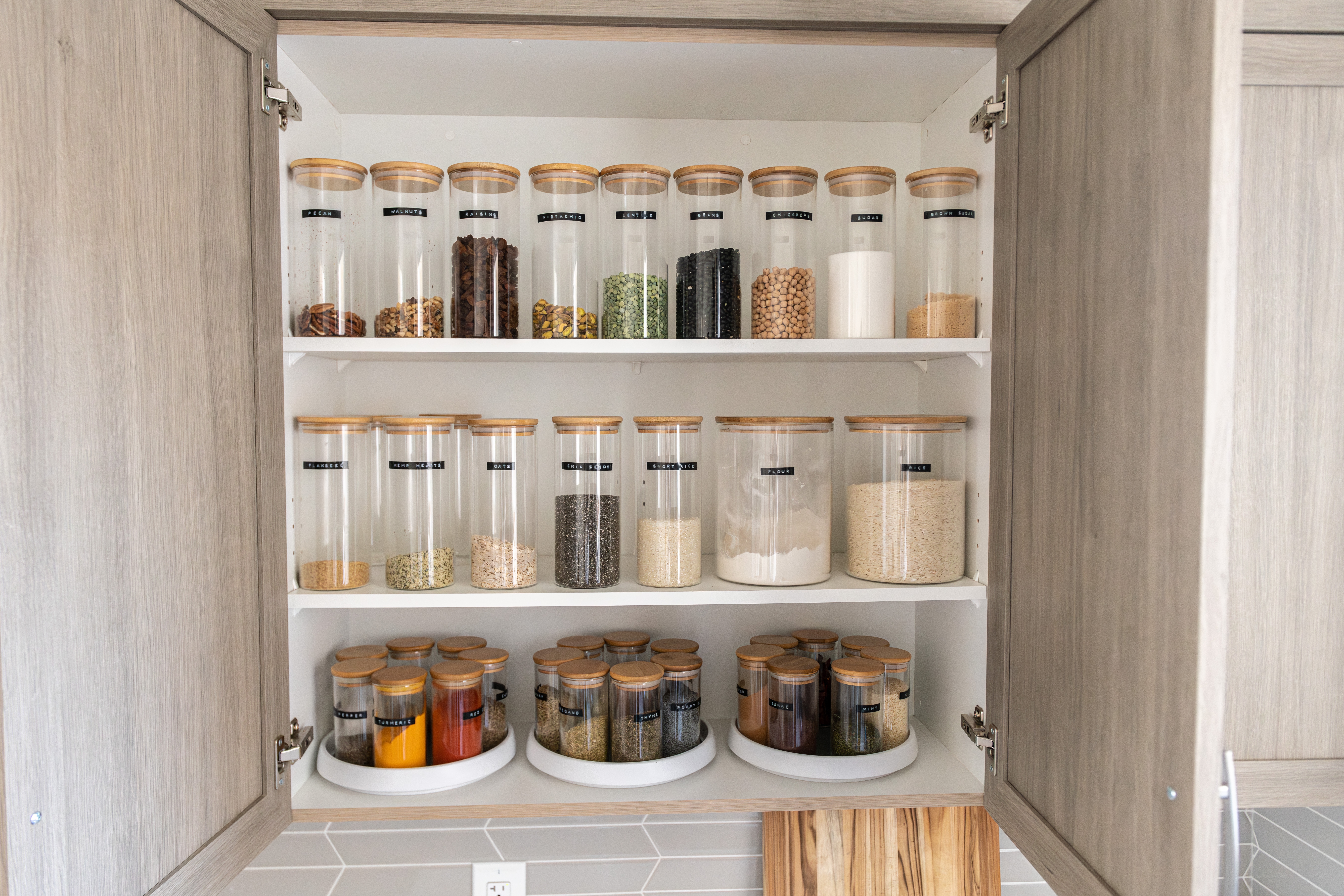 Organized pantry, jars with labels.