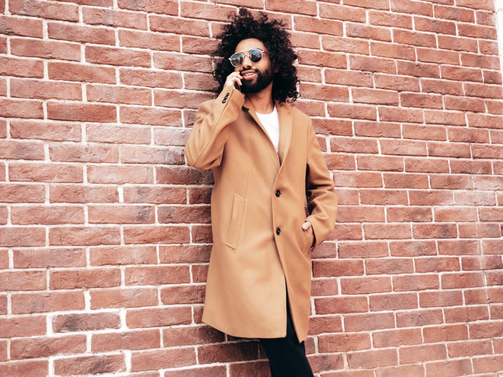 Man wearing a tan wool overcoat.