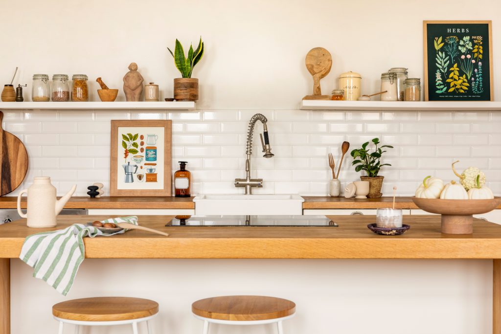 Cozy kitchen decorated with plants and art.