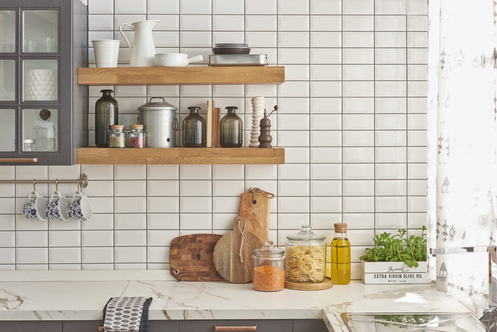 A modern kitchen and countertop with floating shelves.