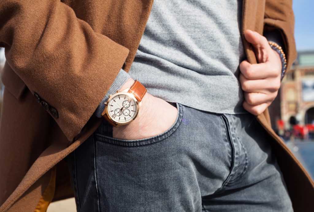 man's hand in pocket, wearing stylish clothing and a wristwatch.