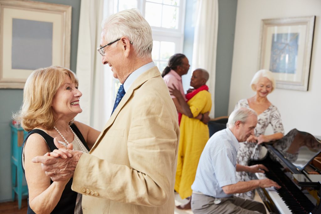 Older man and woman dancing at a dancing class.