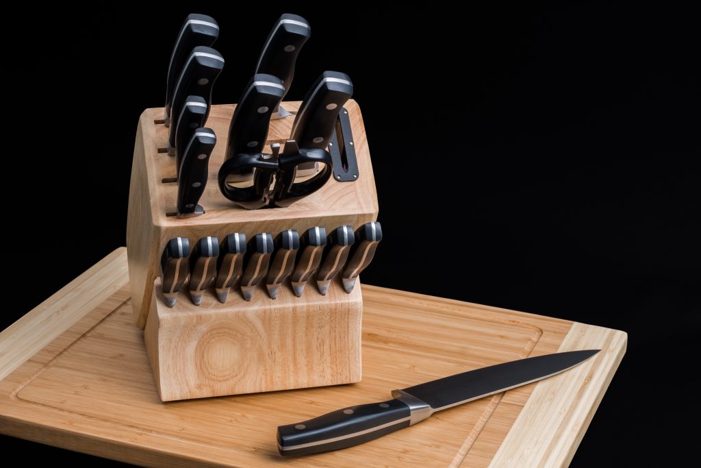 A set of knives in a wood block.