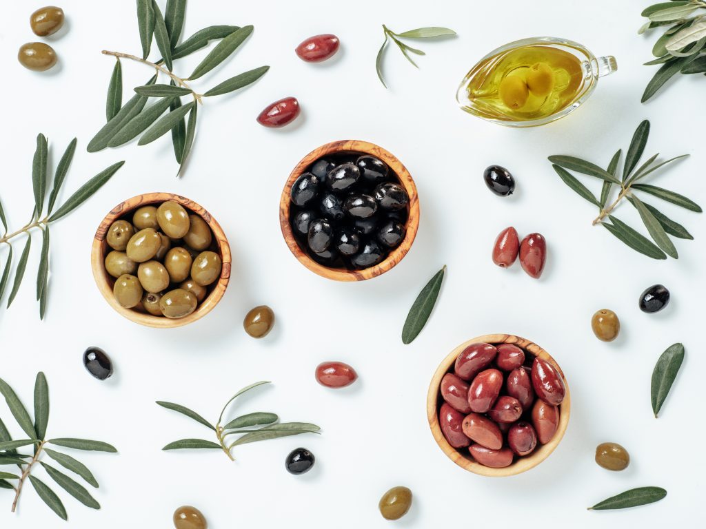 black, green and red olives in bowls.