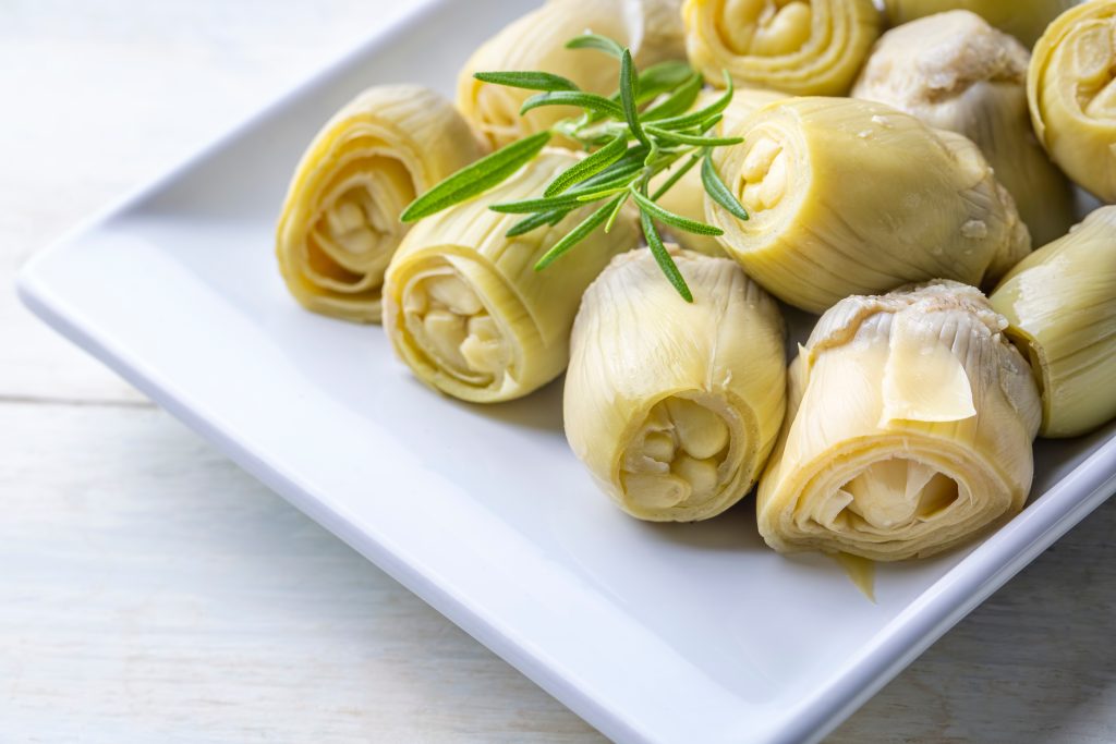 artichoke hearts of a white plate.