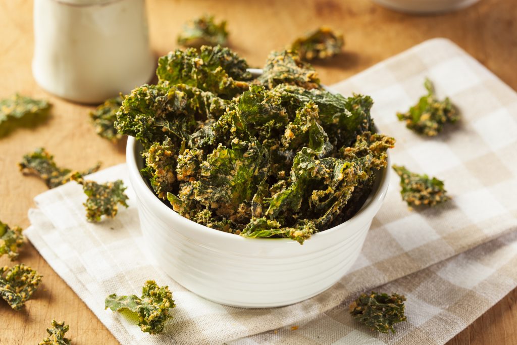 A white bowl of kale chips.