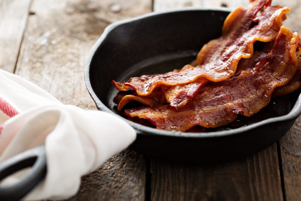 Crispy bacon in an iron skillet.