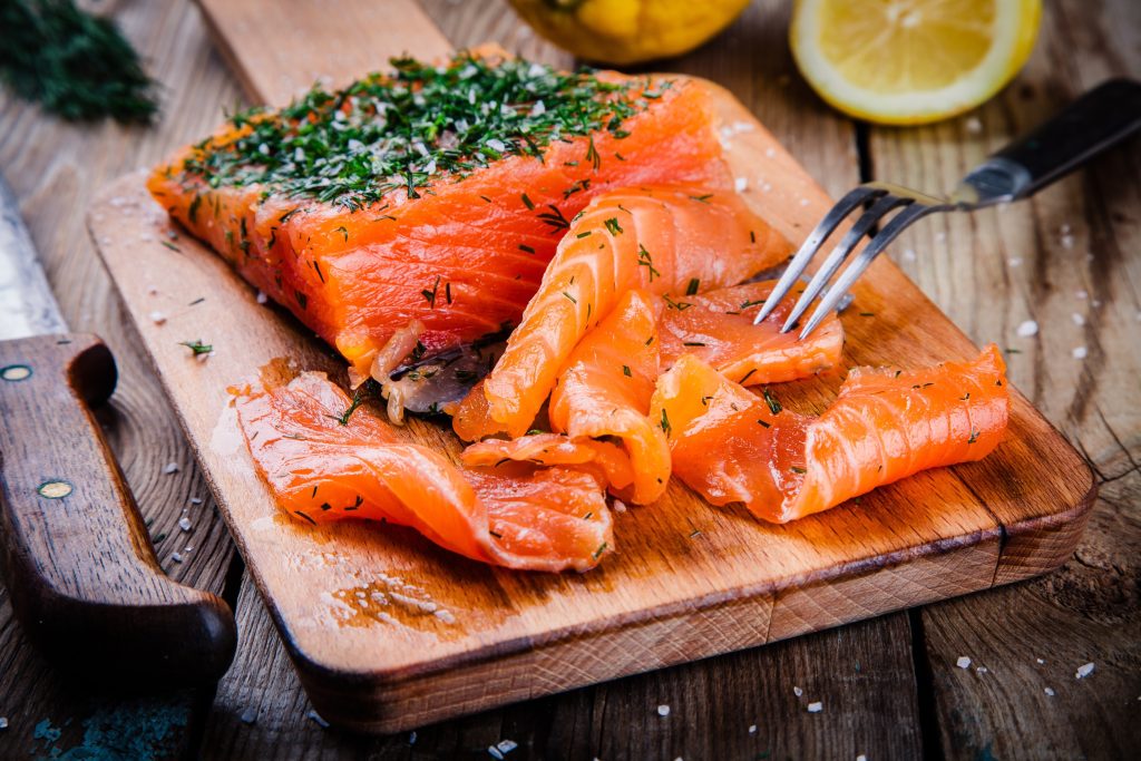 Smoked salmon on a wood cutting board.