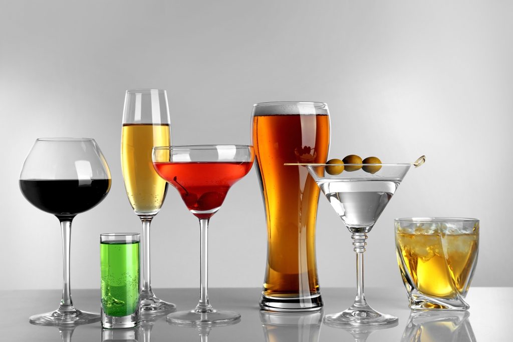 A variety of alcoholic beverages in glasses.